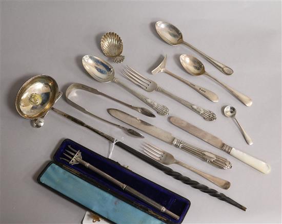 A George III silver caddy spoons and a small group of silver flatware including Victorian pickle fork and a toddy ladle.